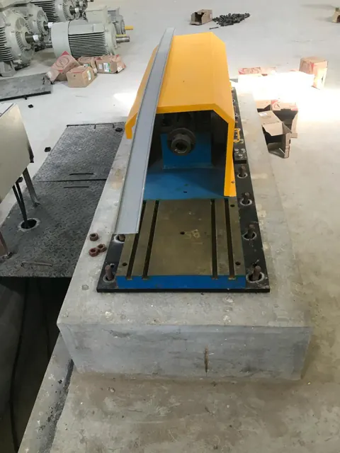 Motor test rig with a protective yellow enclosure