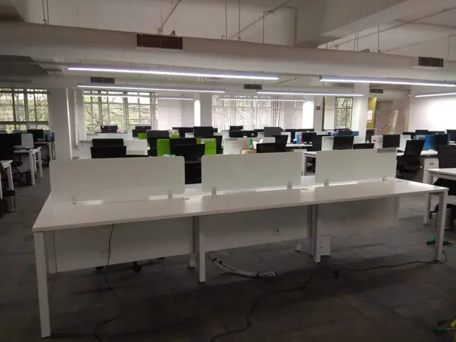 Office workspace with exposed overhead ventilation ductwork